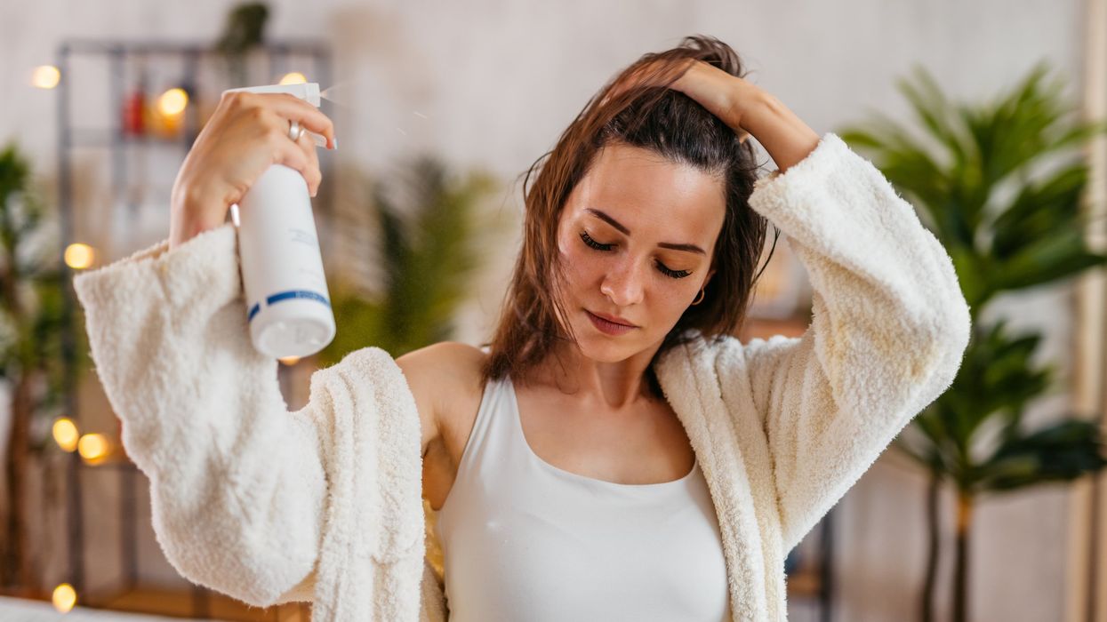 Woman spraying hair product