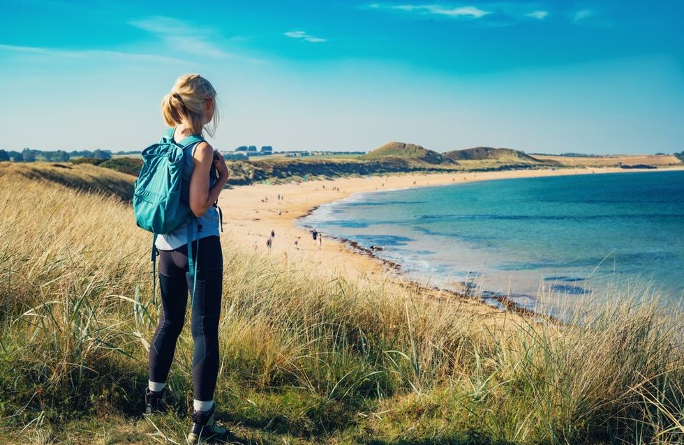 Woman standing at Northumberland Coast