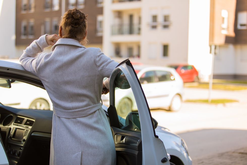 Woman standing in a car door