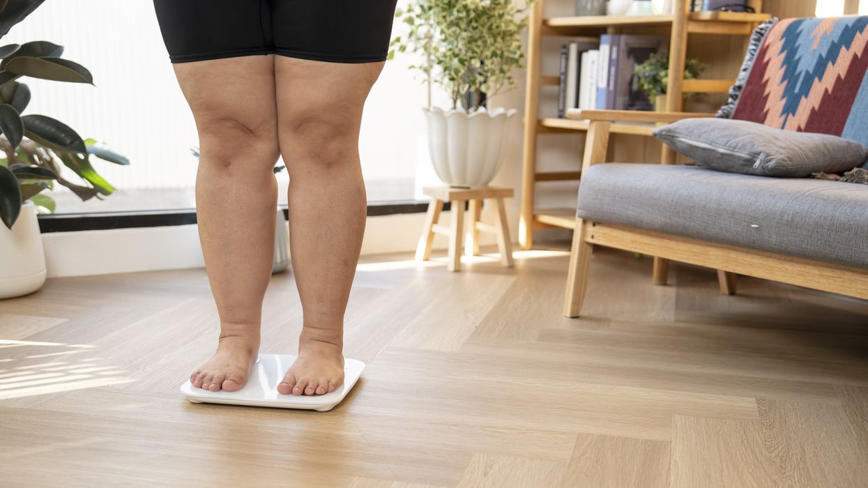 WOMAN STANDING ON SCALE