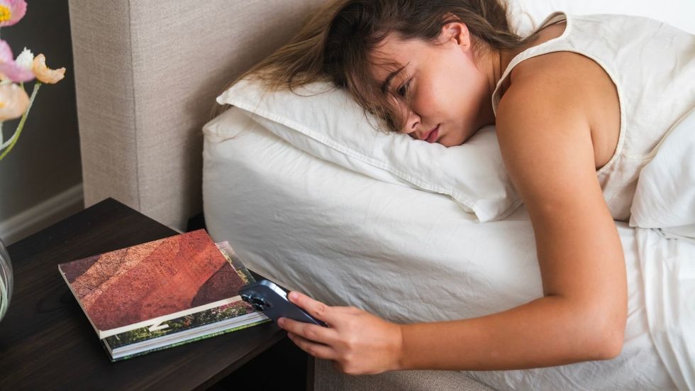 Woman struggling to sleep in bed