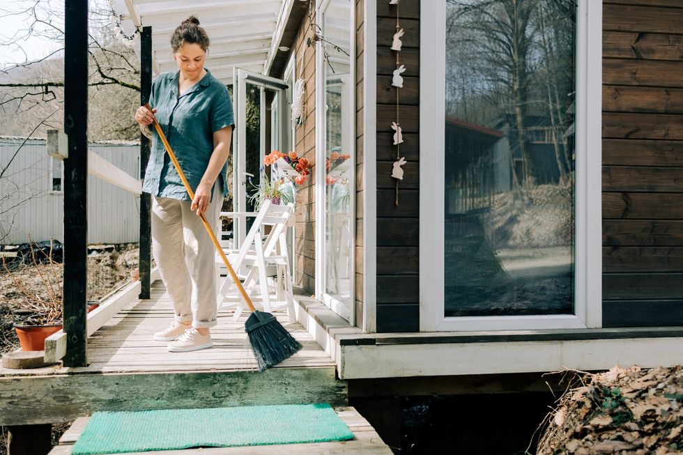 Woman sweeping patio