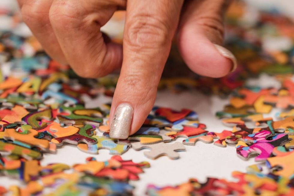 WOMAN TACKLING PUZZLE