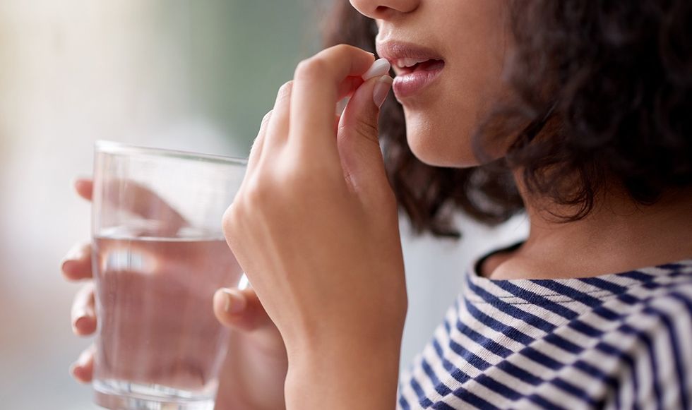Woman taking a pill