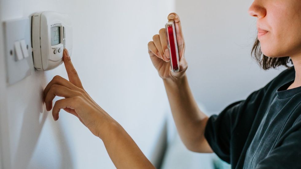 Woman taking reading of energy meter