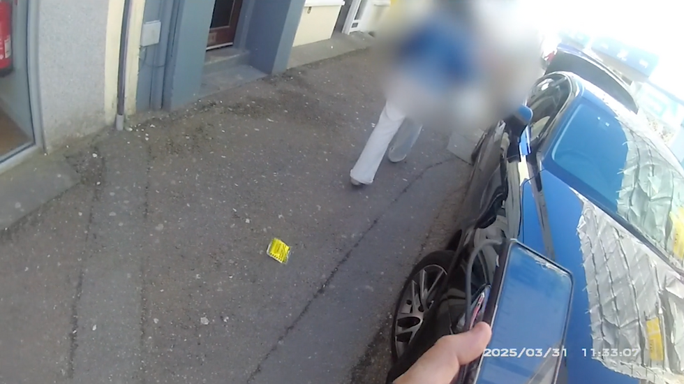 Woman throws parking ticket on floor