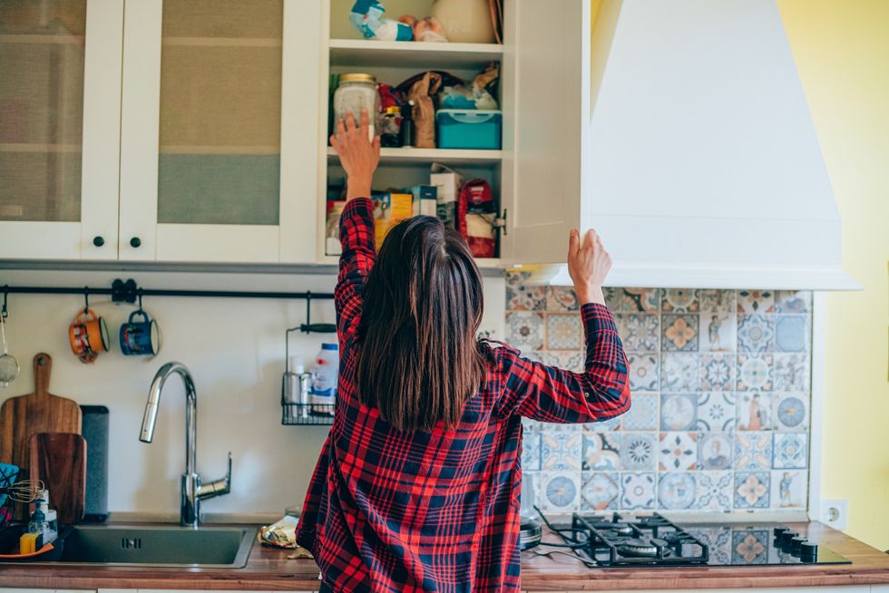 Woman tidying kitchen