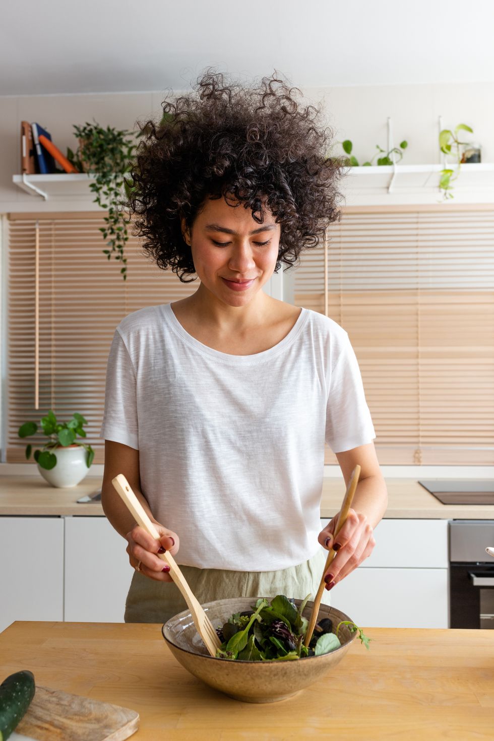Woman tossing salad