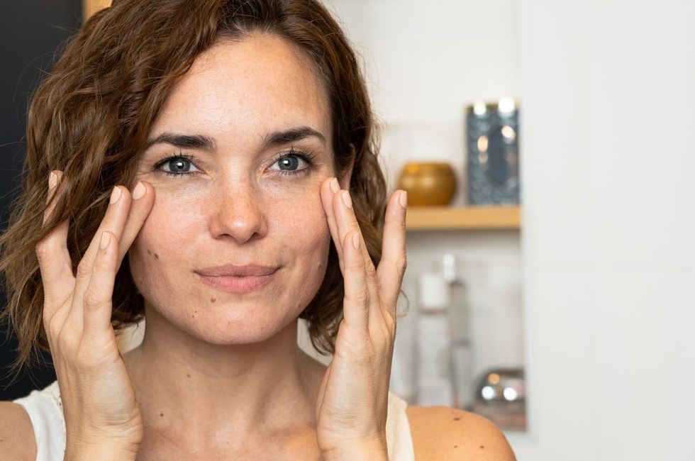 Woman touching face doing skin care
