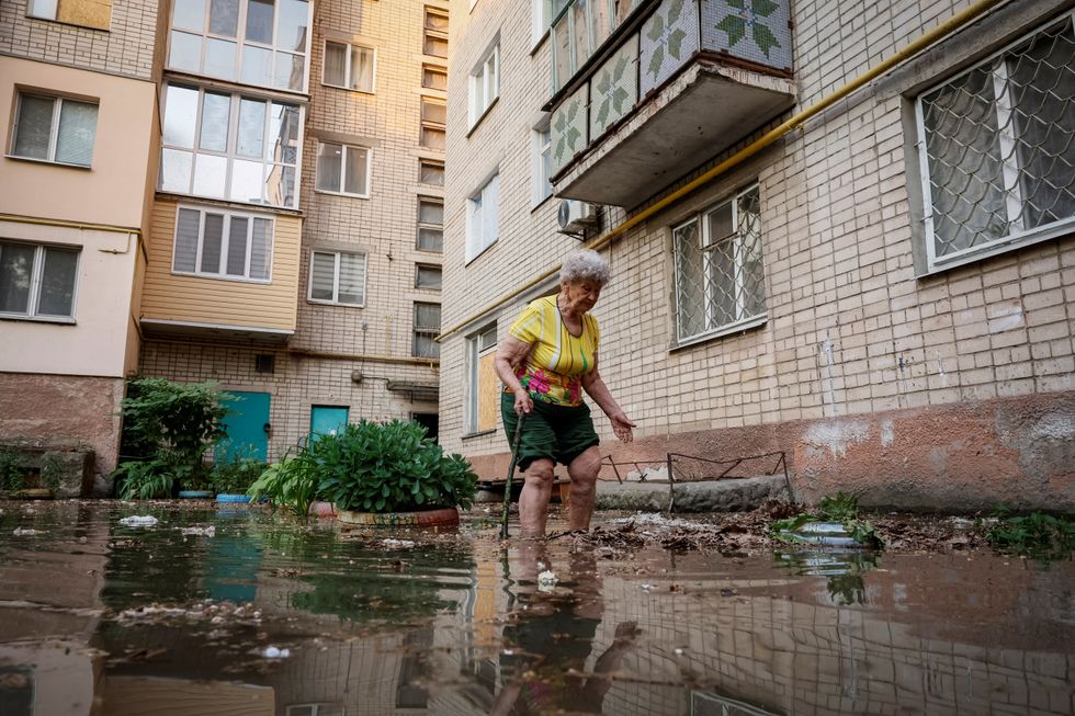 Woman trudges through flooding in