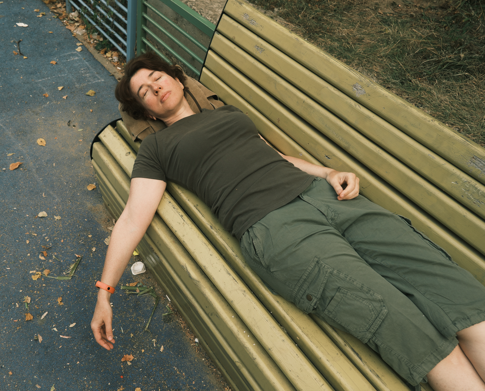 Woman unconscious on a park bench