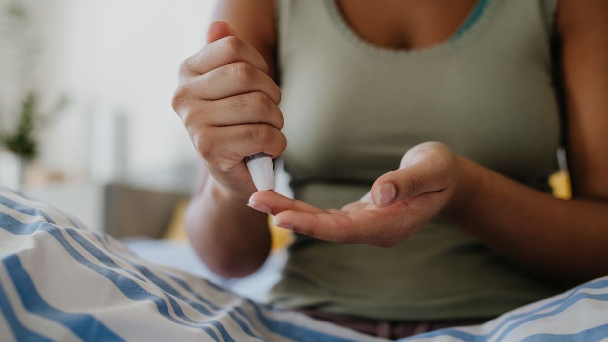 woman using blood monitor