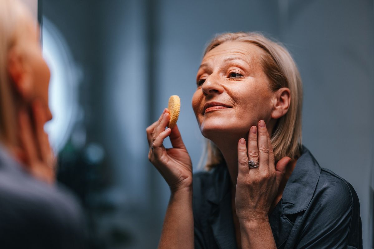 Woman using makeup sponge