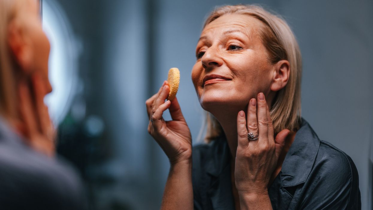 Woman using makeup sponge