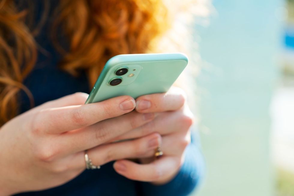 WOMAN USING PHONE APP