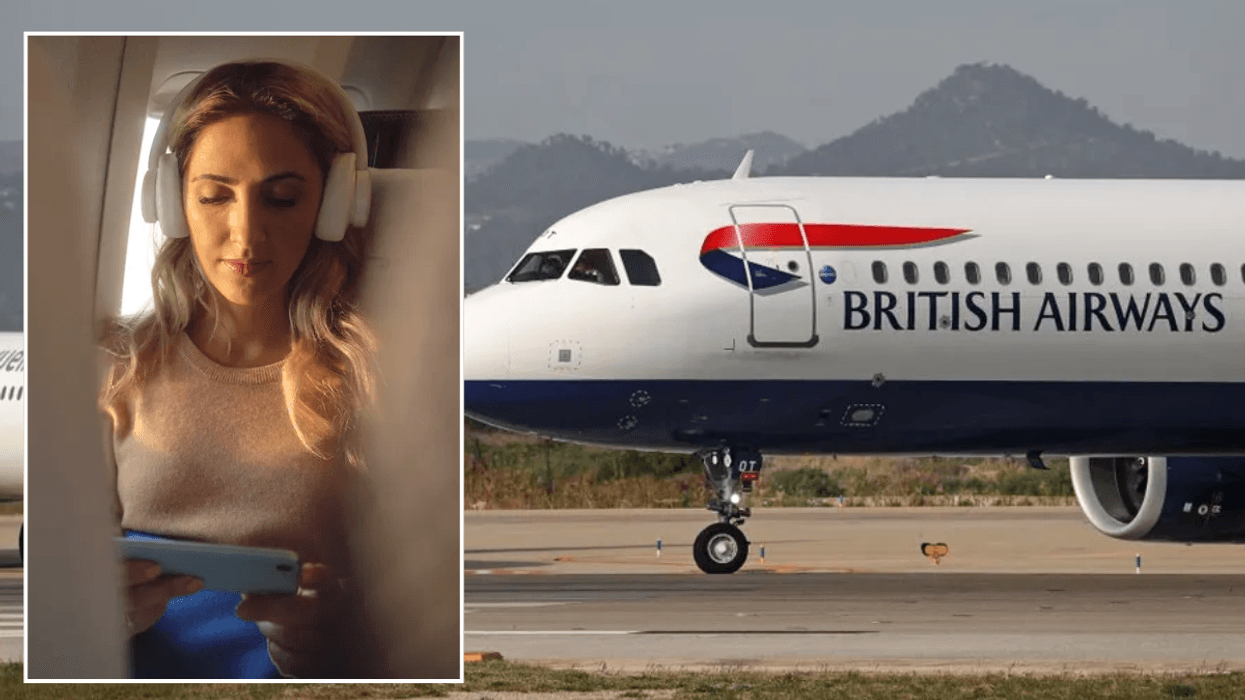 Woman using phone on BA flight / BA plane