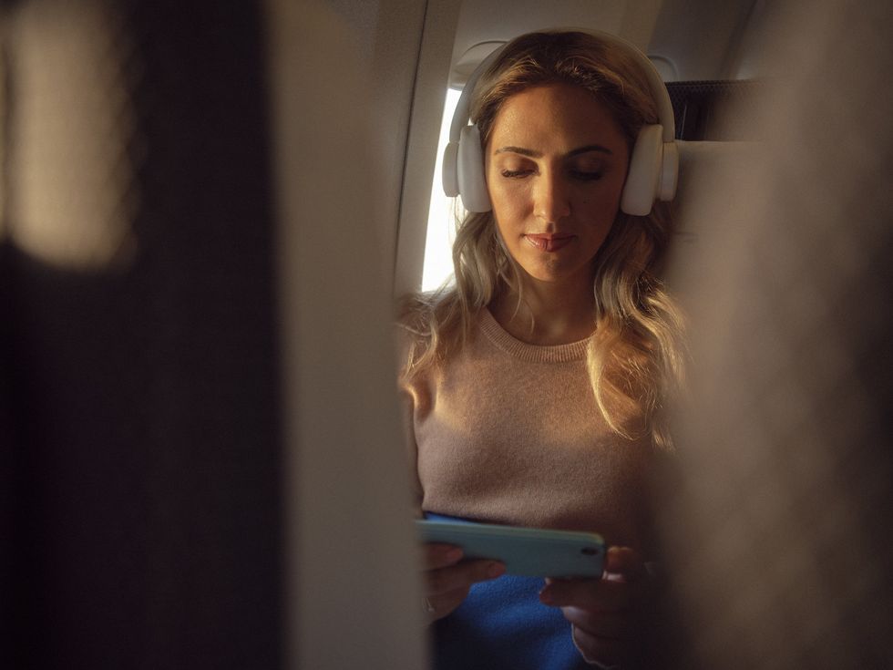 Woman using phone on BA flight