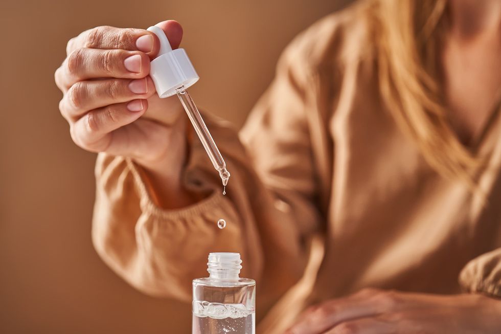 Woman using skin care product