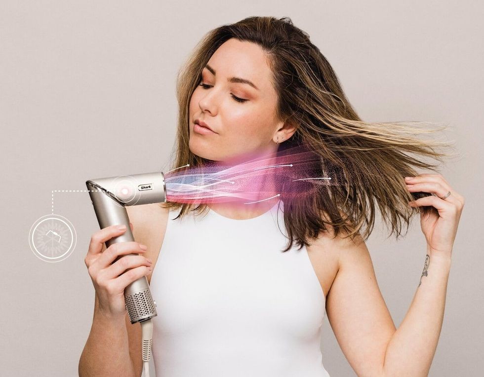 Woman using the Shark FlexStyle 5-in-1 air styler and hair dryer