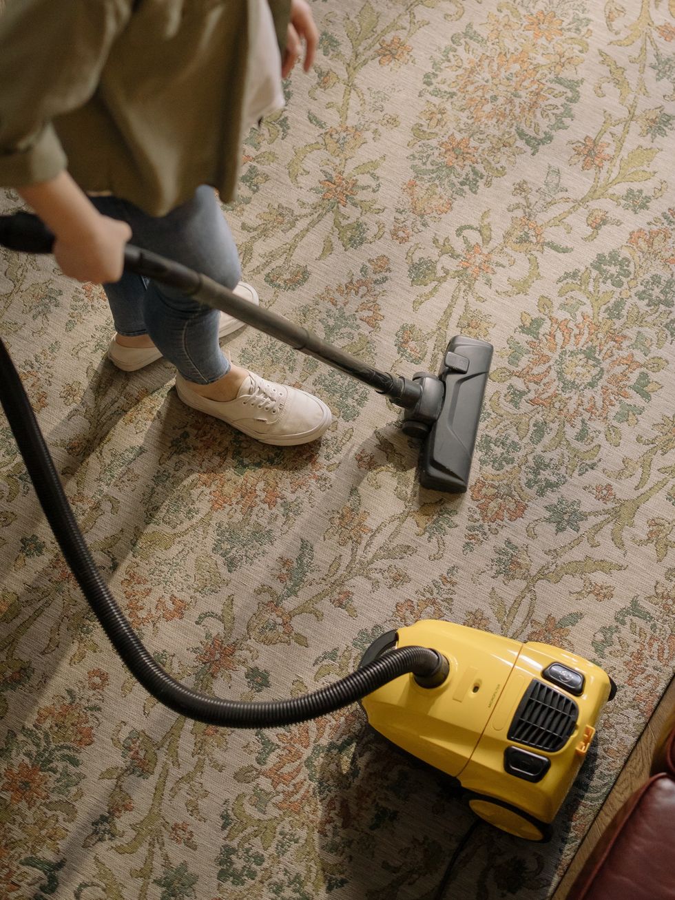 Woman vacuuming carpet