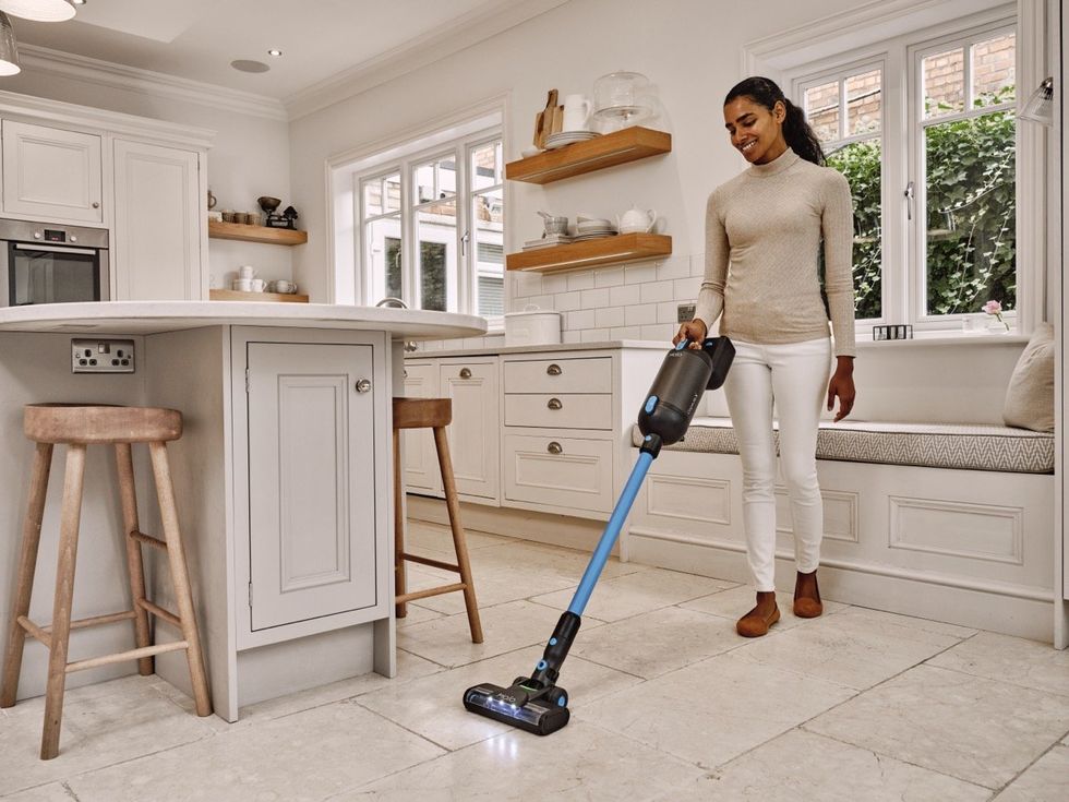 Woman vacuuming floors with the Capsule X