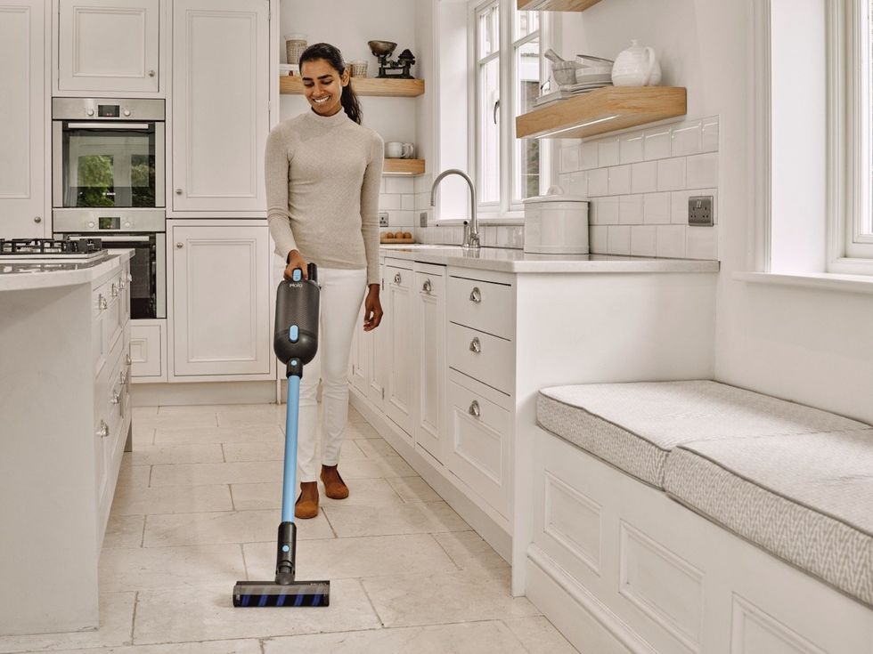Woman vacuuming floors with the Capsule X