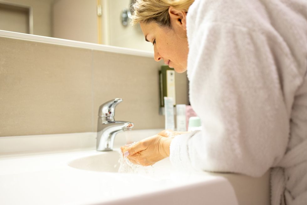 Woman washing her face