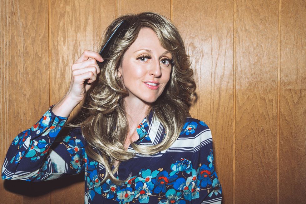 Woman wearing 70s style clothes with 70s style shag haircut