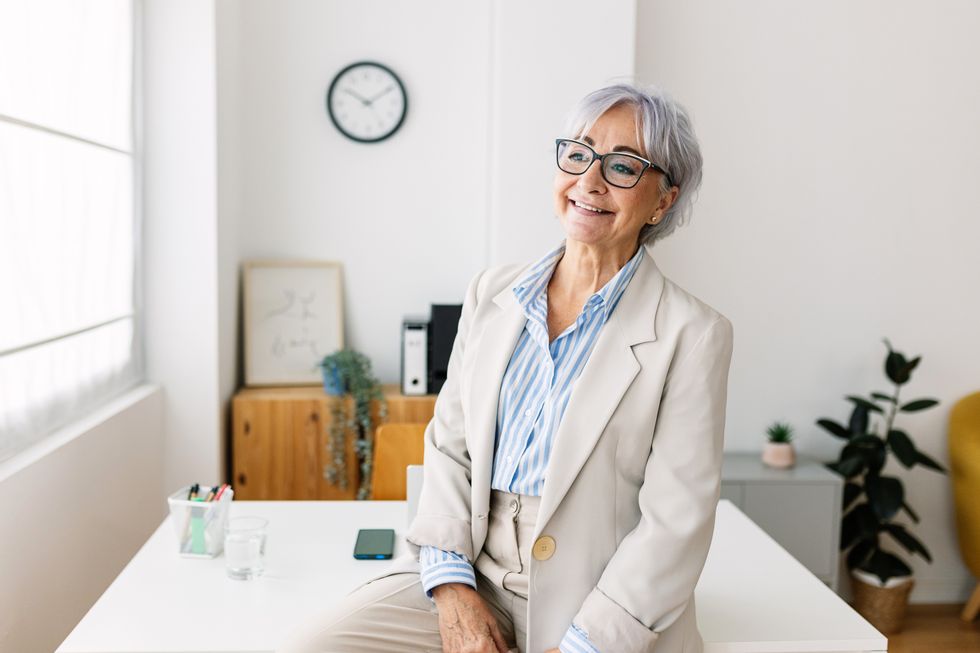 Woman wearing glasses and suit