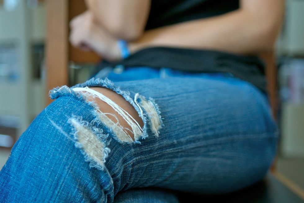 Woman wearing ripped jeans