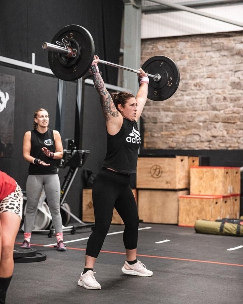 Woman weight lifting at gym