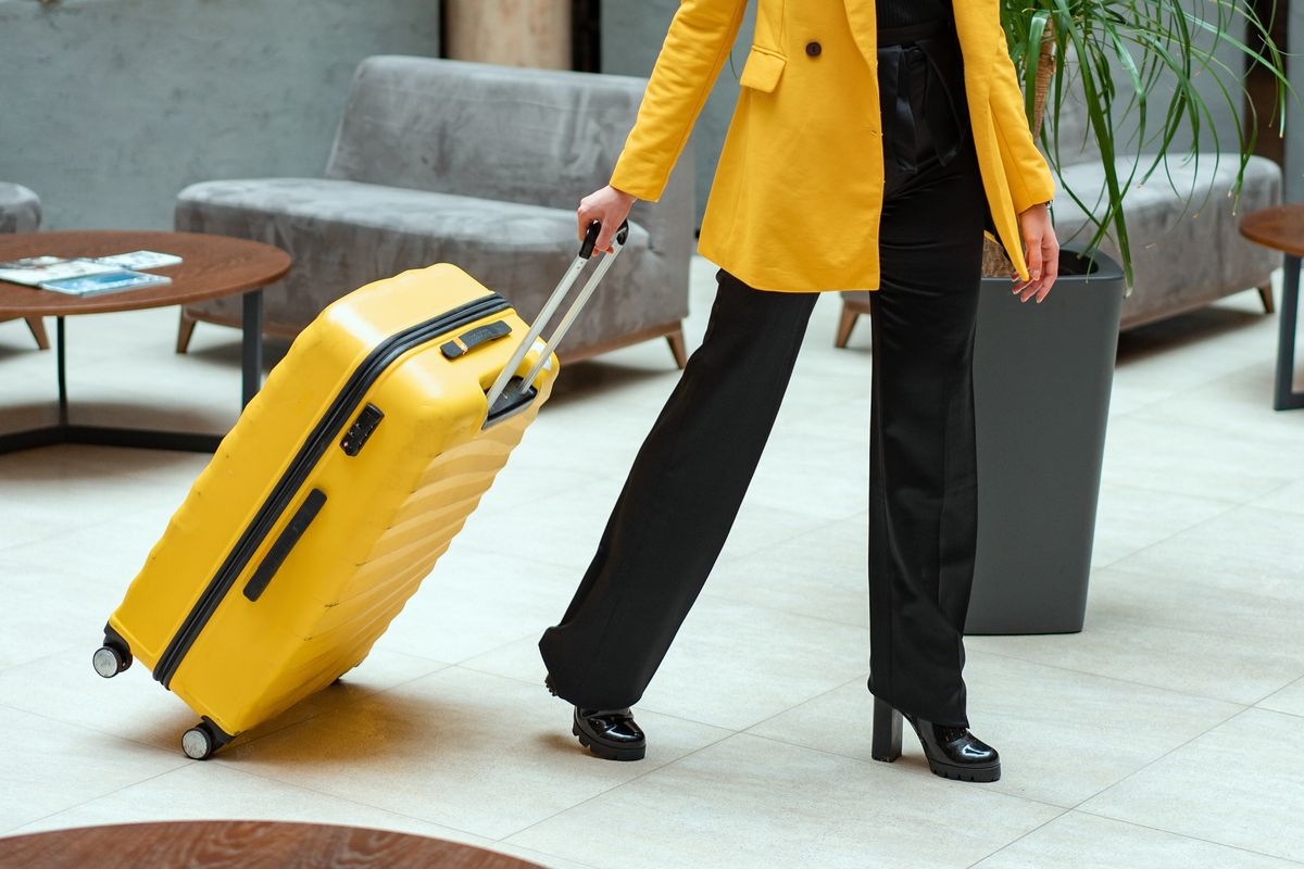 Woman wheeling a suitcase