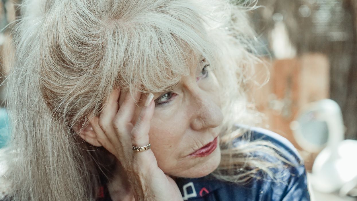 Woman with head in hands