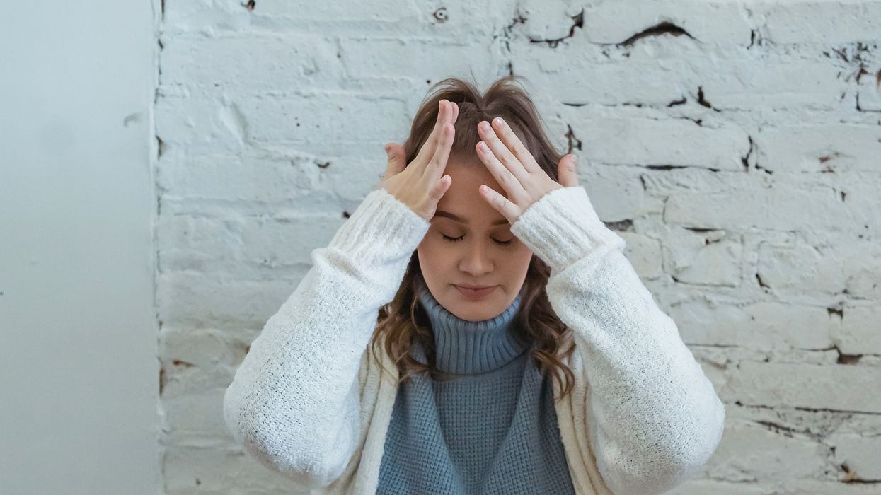 Woman with migraine holding head