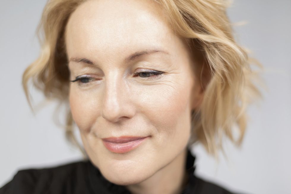 Woman with short, blonde, wavy hair