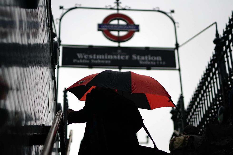 Woman with umbrella at Westminster Station