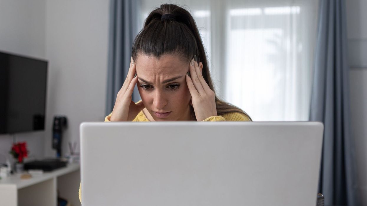 Woman worried at laptop