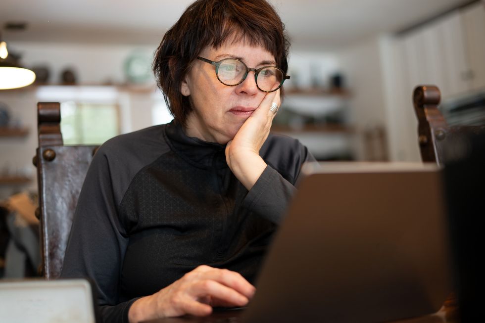 Woman worried at laptop