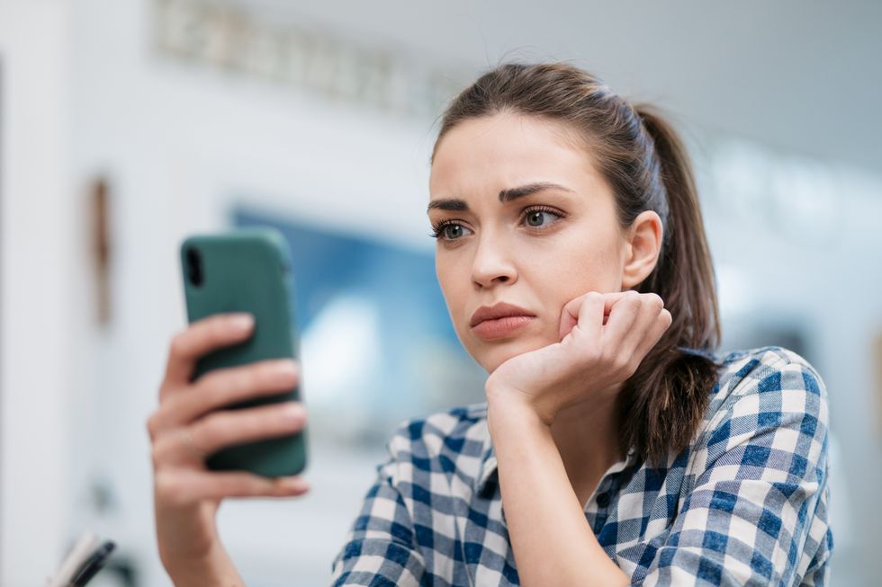 Woman worried looking at her phone
