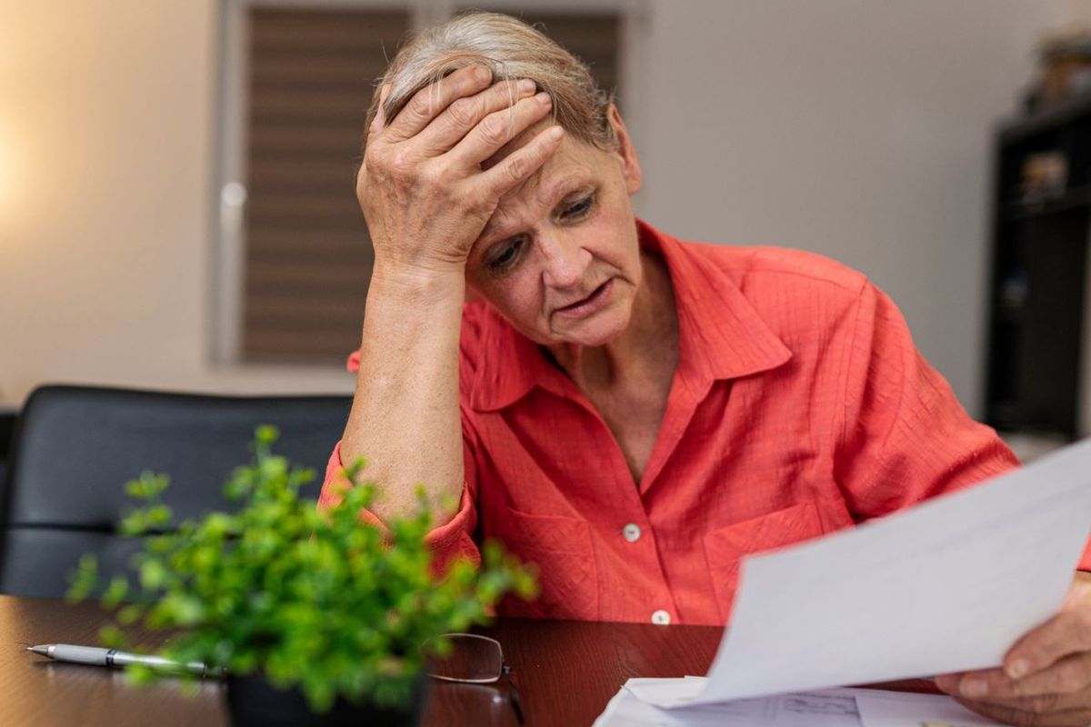 Woman worried looking at letters