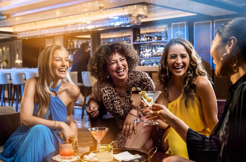 women enjoying drinks on cruise ship