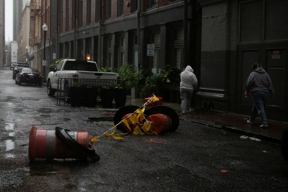 Women walk in the rain as Hurricane Ida makes landfall in Louisiana, in New Orleans.
