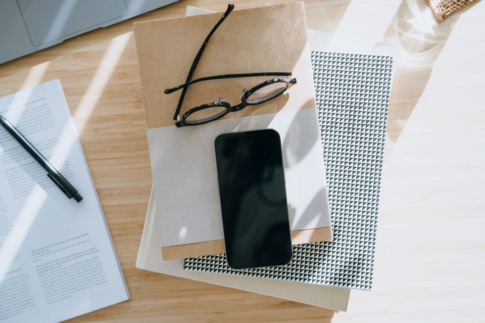 Work from home desk, papers, notebook and mobile phone