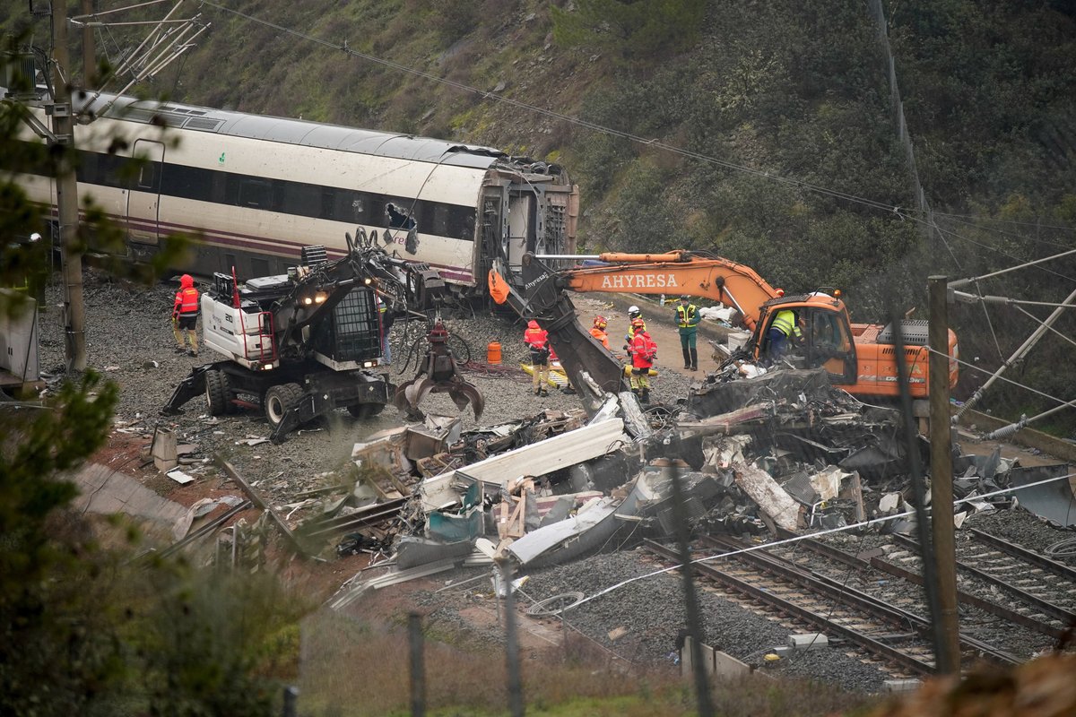 Workers operate heavy machinery as removal works continue following a deadly derailment of two high-speed trains near Adamuz