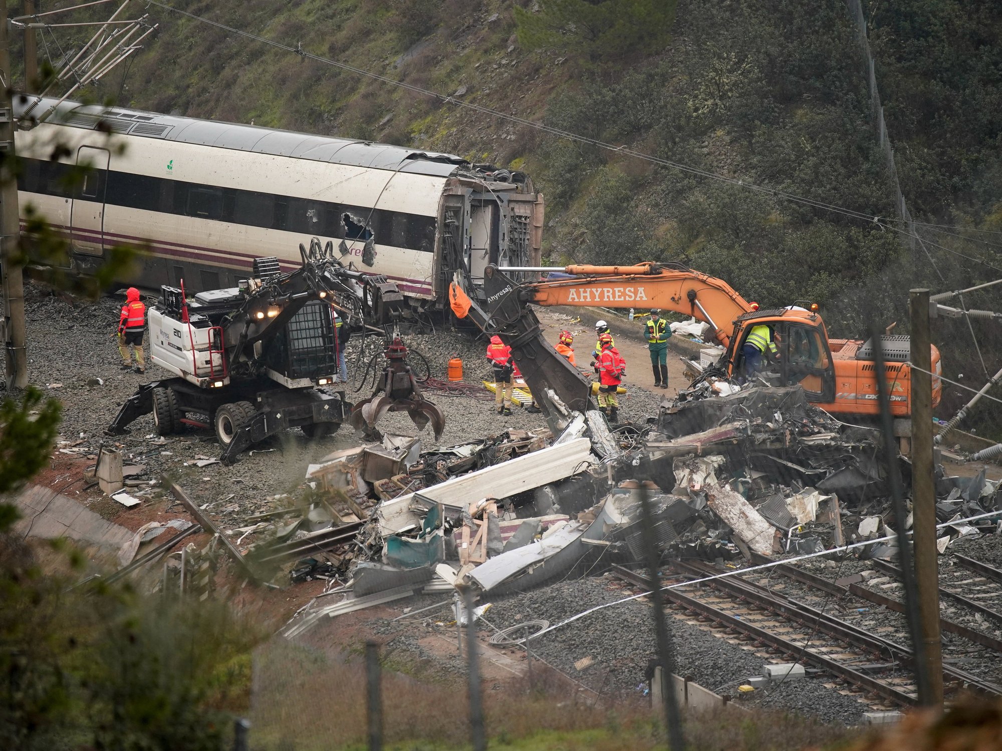 Workers operate heavy machinery as removal works continue following a deadly derailment of two high-speed trains near Adamuz