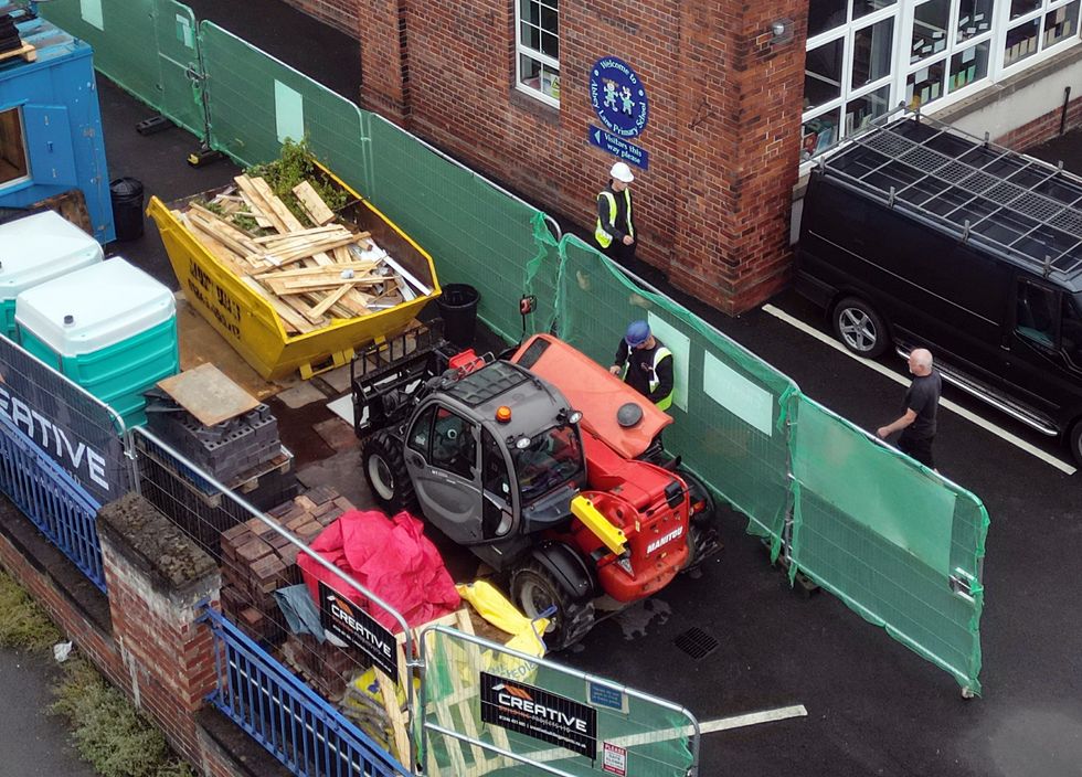 Workmen at Abbey Lane Primary School in Sheffield, which has been affected with sub standard reinforced autoclaved aerated concrete (Raac)