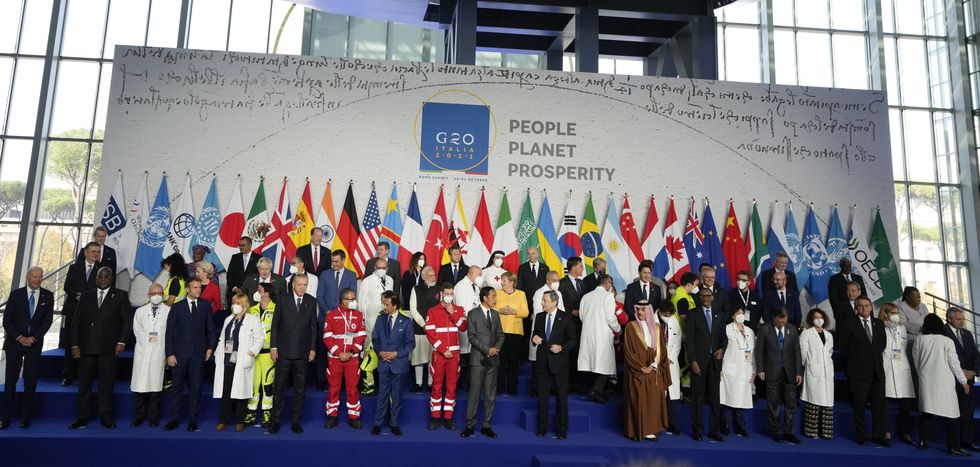 World leaders pose with medical personnel for a group photo at the La Nuvola conference center during the G20 summit in Rome, Italy. Picture date: Saturday October 30, 2021.