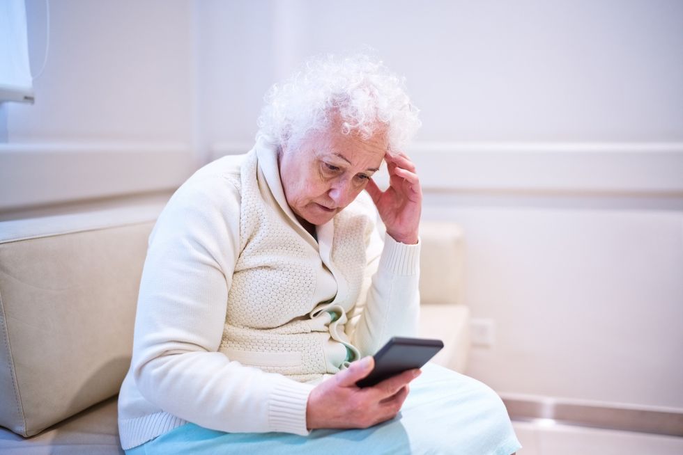 Worried woman looking at phone