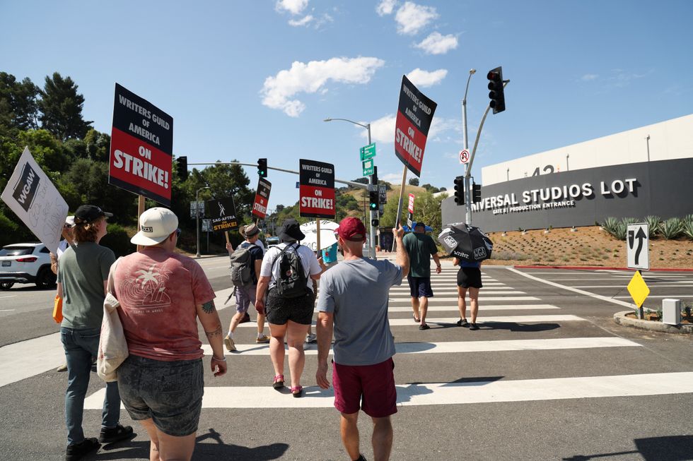 Writers Guild of America (WGA) writers walk the picket line during their ongoing strike outside NBCUniversal Studios in Los Angeles