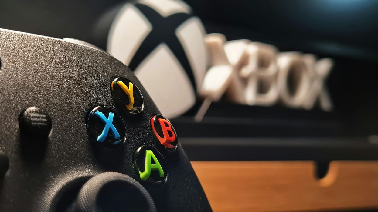 Xbox gaming controller in front Xbox logo